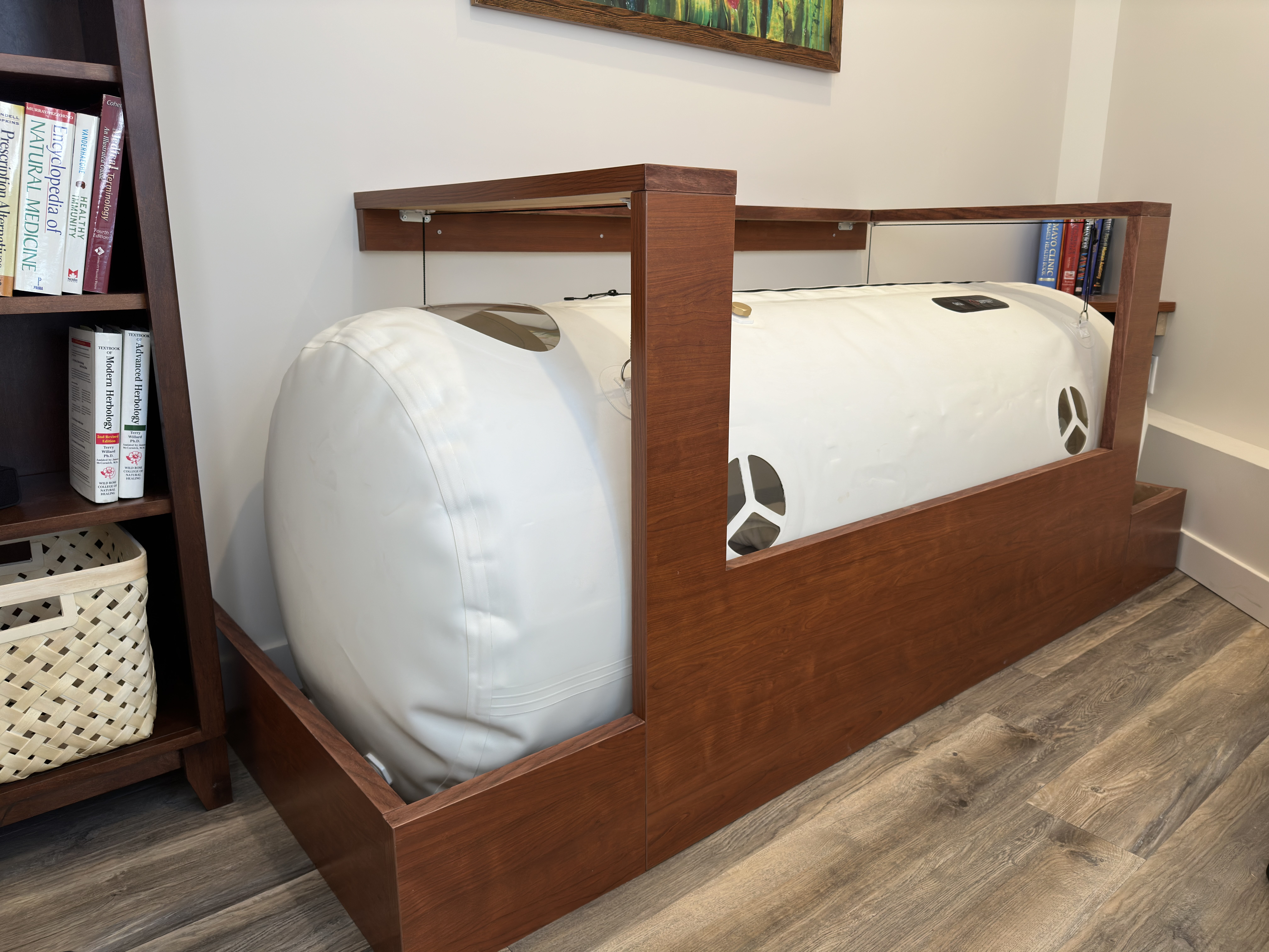 The wood-framed soft-shell hyperbaric chamber in the calm relaxation room.